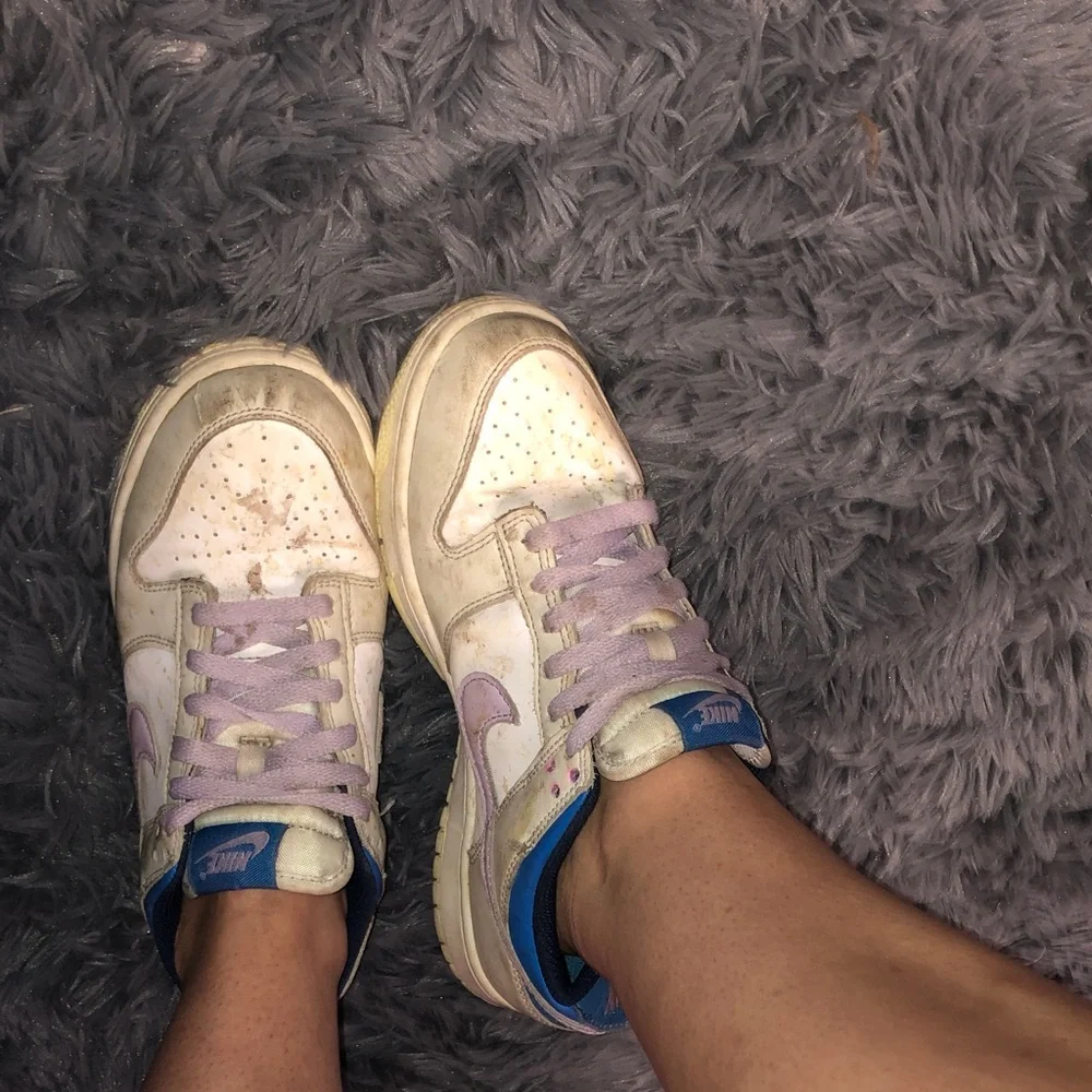 Well worn women’s Nike White dunks sneakers with Light Purple Accents WW